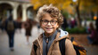 © AS Photo Family - Portrait of a smiling little boy with glasses and backpack in the autumn park. Generative AI.