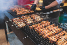 Food Festival With Food Stall Kiosk, Open-air Outdoor Fair Market, Assortment Of Different Traditional European Grilled Barbecued Street Food With Sausages, Bbq, Chicken, Pork And Lamb On A Large Pan