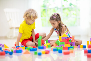 Wall Mural - Child playing with toy blocks. Toys for kids.