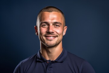 Wall Mural - Close-up portrait photography of a satisfied boy in his 30s wearing a sporty polo shirt against a navy blue background. With generative AI technology