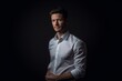 © Markus Schröder - Lifestyle portrait photography of a glad boy in his 30s wearing an elegant long-sleeve shirt against a matte black background. With generative AI technology