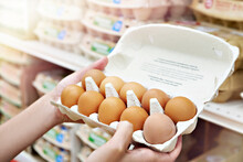 Hands With Packages Of Eggs