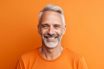 Wall Mural - Medium shot portrait photography of a joyful mature man wearing a casual t-shirt against a tangerine orange background. With generative AI technology