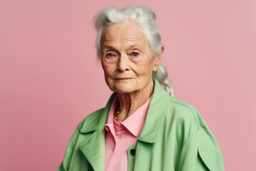 Wall Mural - Medium shot portrait photography of a tender old woman wearing a chic cardigan against a pastel green background. With generative AI technology