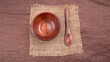 © Raksha Shelare - Empty wooden bowl and wooden spoon isolated with copy space.