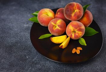 Wall Mural - Harvest of peaches for food or juice. fresh organic fruit, vegan food. Large peaches on dark table background, selective focus.