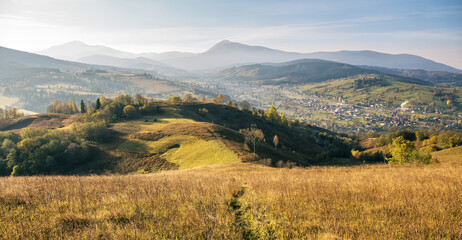 foggy summer landscape with green rural field in the alps with beautiful fresh green mountain pastur