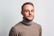 © Markus Schröder - Environmental portrait photography of a glad boy in his 30s wearing a classic turtleneck sweater against a pearl white background. With generative AI technology