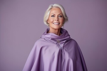 Sticker - Medium shot portrait photography of a glad mature woman wearing a unique poncho against a lilac purple background. With generative AI technology