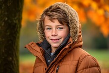 Sports Portrait Photography Of A Grinning Boy In His 30s Wearing A Cozy Winter Coat Against An Autumn Foliage Background. With Generative AI Technology