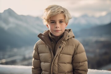 Wall Mural - Urban fashion portrait photography of a glad kid male wearing a cozy winter coat against a mountain range background. With generative AI technology