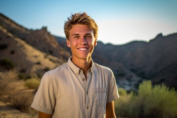 Canvas Print - Eclectic portrait photography of a satisfied boy in his 30s wearing a casual short-sleeve shirt against a mountain range background. With generative AI technology