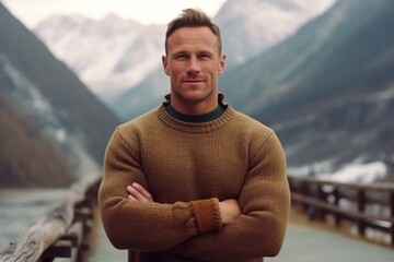 Wall Mural - Medium shot portrait photography of a satisfied boy in his 30s wearing a cozy sweater against a serene snow-capped mountain background. With generative AI technology