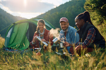 Group of happy friends enjoy in their camping day in nature.