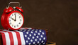 Alarm clock and USA flag. US presidential election, voting banner background with copy space. Independence day.