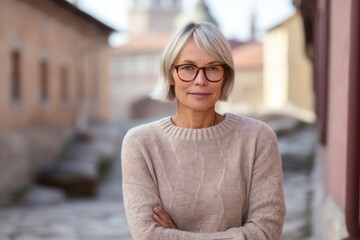 Wall Mural - Urban fashion portrait photography of a satisfied mature girl wearing a cozy sweater against a peaceful monastery background. With generative AI technology