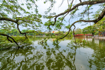 Wall Mural - view of The Huc Red Bridge and Ngoc Son temple in the center of Hoan Kiem Lake, Ha Noi, Vietnam.