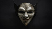 A Creepy Mask With A Dark Background