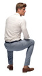 Back view of an Isolated sitting handsome young man wearing a white shirt and blue chino trousers,  cutout on transparent background, ready for architectural visualisation.