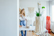 © Iryna - Adult attractive woman create working on an unfinished macrame piece, weaving ropes. Creative craftswoman in workshop space. Weaving art hobby concept.