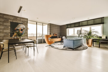 a living room with wood paneling on the walls and white hardwood flooring in the center of the room