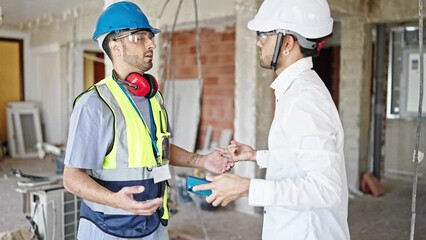 Wall Mural - Two men builder and architect arguing at construction site