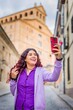 © Sangiao_Photography - Smartphone technology holiday vacation. Latin American mid-female. Lifestyle selfie in Salamanca.