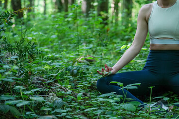 woman doing yoga in the forest