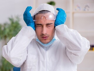 Young male chemist working in the lab