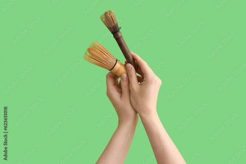 Woman with bamboo chasens on green background