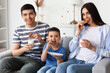 © Pixel-Shot - Happy family eating cookies with milk at home
