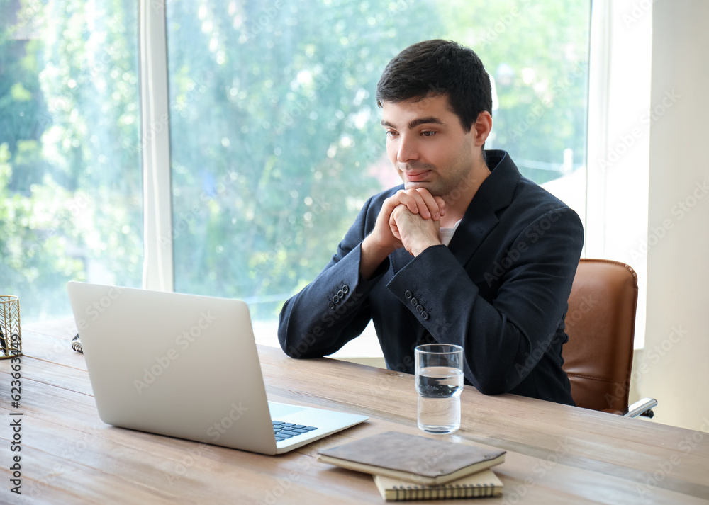 Young man having job interview online at home