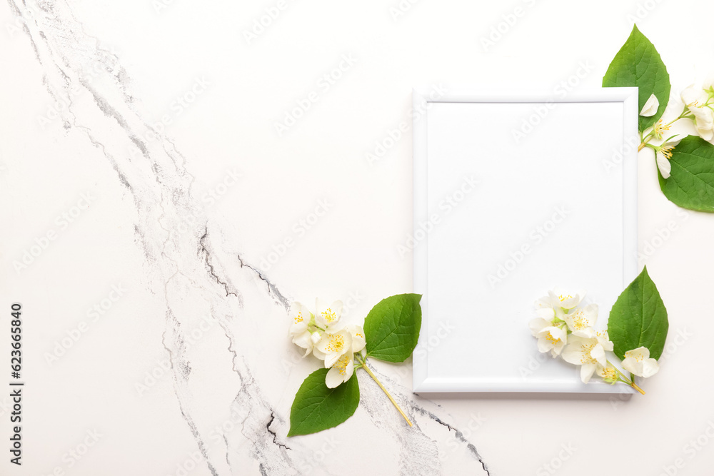 Blank photo frame and beautiful flowers on white background