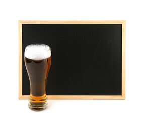 Glass of cold beer and blank chalkboard on white background