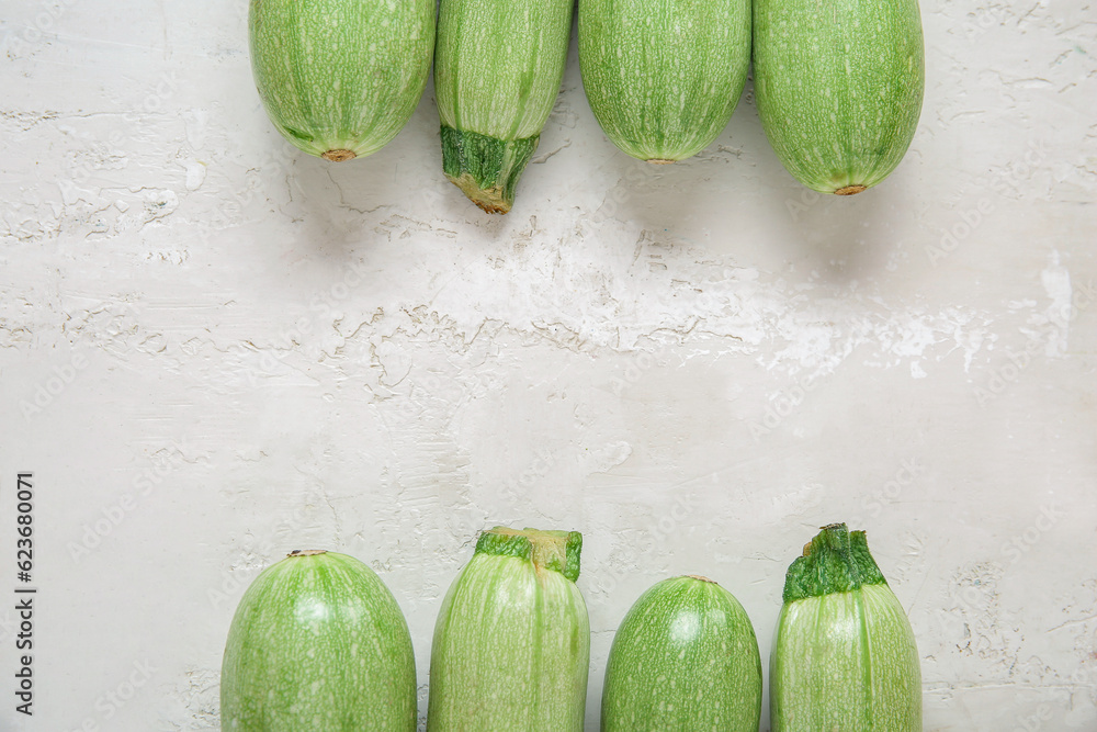 Frame made of fresh green zucchini on light background