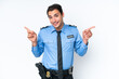 © luismolinero - Young police caucasian man isolated on white background pointing finger to the laterals and happy