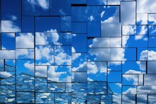 Tessellated Mosaic Of Mirrors Reflecting The Blue Sky And Clouds