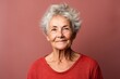 © Anne Schaum - Portrait of a smiling senior woman with grey hair posing at studio