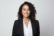 © Robert MEYNER - Portrait of a smiling businesswoman with curly hair over gray background