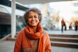 © Robert MEYNER - Portrait of a smiling senior woman standing outdoors in the city.