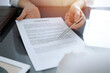 © rogerphoto - Business people sitting and discussing contract in office, closeup. Partners or lawyers working together at meeting before signing papers. Teamwork and partnership
