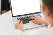 © iSomboon - a senior woman is using a laptop with a credit card , white blank screen with clipping path.