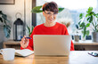 © leszekglasner - Smiling short haired woman with glasses at home office looking at camera