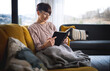 © leszekglasner - Reading a book in cozy living room and on comfortable sofa