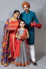 Portrait of Indian family candid moment with gift ,Punjabi sikh family having fun together