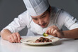 © View Stock - Middle-aged man in chef's uniform prepares delicious food