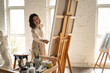 © View Stock - Young female painter painting in a studio