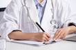 © View Stock - A young female doctor write medical records