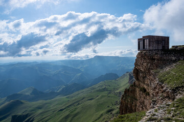 Two houses on the top of a rock