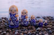 © Станислав  - A group of nesting dolls on the river bank.